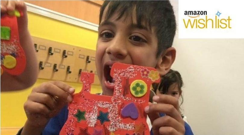 boy holding picture with Amazon wishlist logo