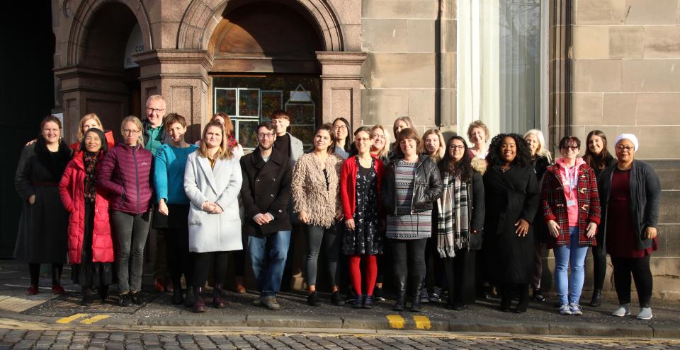 staff in front of building