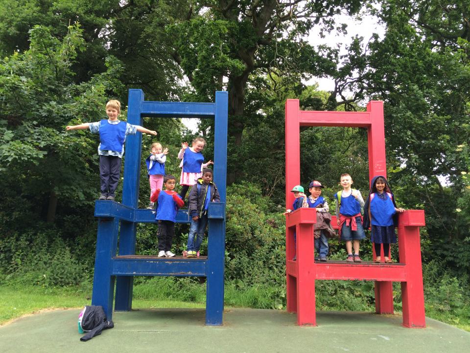 children on large chairs in the park