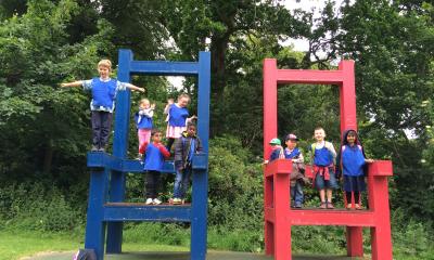 children on large chairs in the park